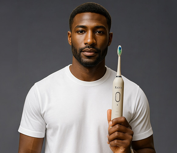 a man holding Rava Smiles electric toothbrush