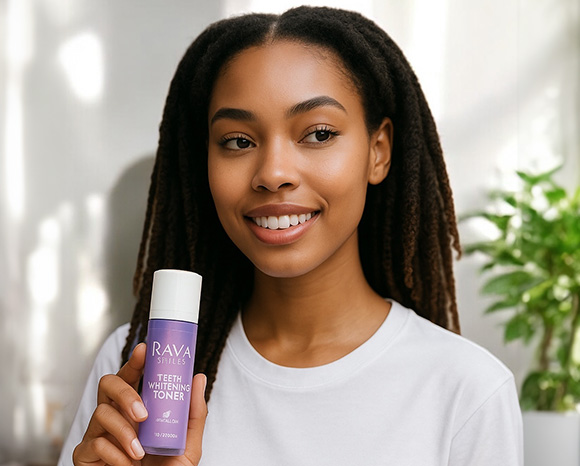 a woman with braided hair holding Rava Smiles' teeth whitening toner