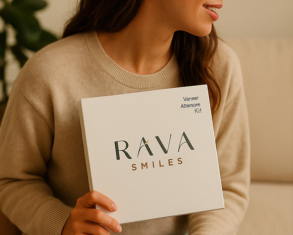 a woman holding Rava Smiles' vaneer aftercare kit